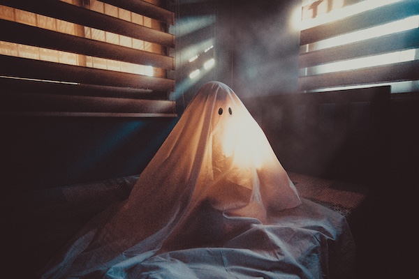 Ghost sitting on bed